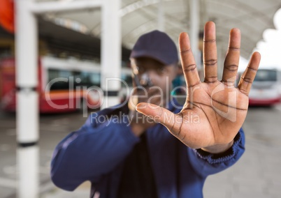 security guard saying stop with his hand in the bus station