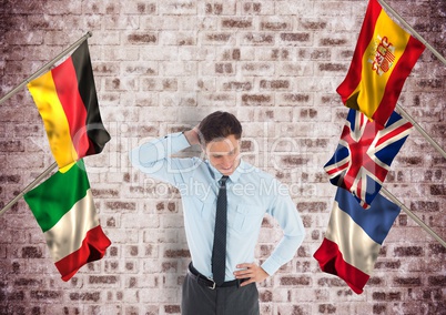 main language flags around business young man. Bricks wall background