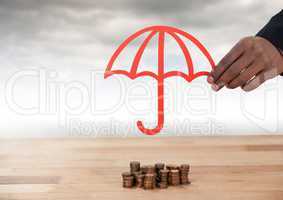 Cut out umbrella protective over money coins with clouds