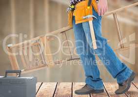 Construction Worker with ladder in front of construction site