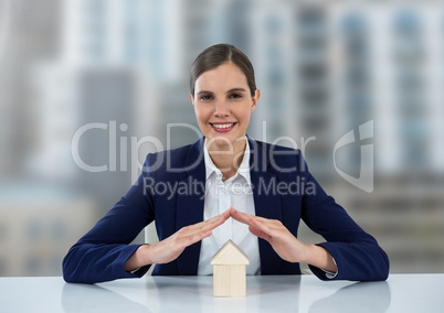 House under woman's protective hands in city