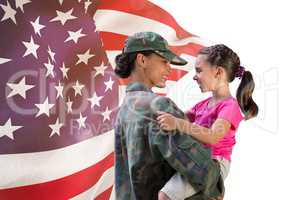soldier and daughter  in front of usa flag