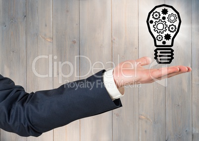 Arm with lightbulb graphic and flare against grey wood panel
