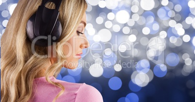 Blond-hair girl listenning music with headphones back to the photo with blue background