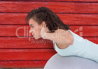 fitness woman with big ball with red wood background