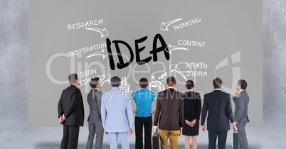 Rear view of business people looking at text on gray background