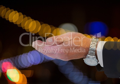 Businessman Hand with rich watch with sparkling light bokeh background