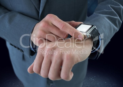 Businessman holding watch with dark ground background