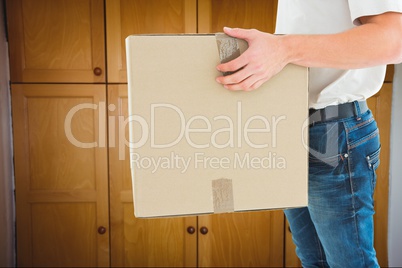 Delivery man standing on against a cupboard