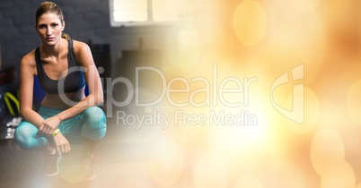 Woman crouching in gym and yellow bokeh transition