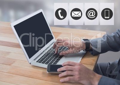 Businessman on laptop with contact icons by windows