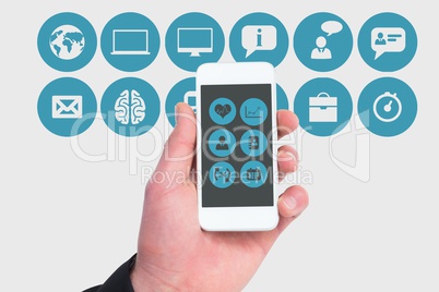 hand showing the screen of a smartphone against mobile applications icons background