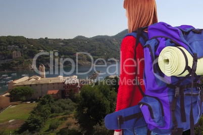 Woman traveler with hiking bag against beautiful view