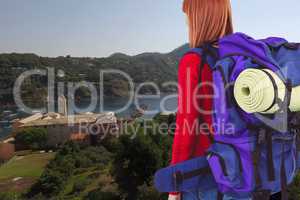 Woman traveler with hiking bag against beautiful view