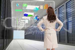 Business woman watching at a graph on the server room
