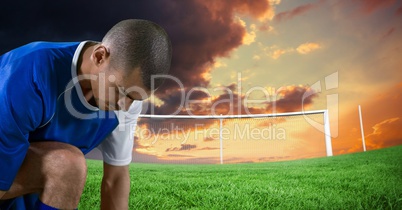 soccer player tying the shoes in the field