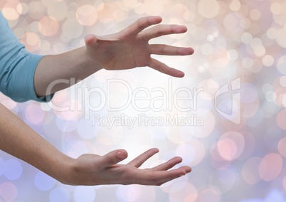 Hands open erratic with sparkling light bokeh background