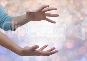 Hands open erratic with sparkling light bokeh background