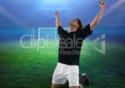 soccer player on knees celebrating a goal