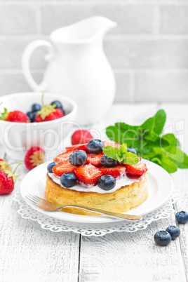 Delicious berry cheesecake with fresh strawberry and blueberry on white background