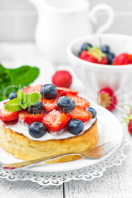 Delicious berry cheesecake with fresh strawberry and blueberry on white background