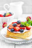 Delicious berry cheesecake with fresh strawberry and blueberry on white background