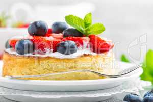 Delicious berry cheesecake with fresh strawberry and blueberry on white background