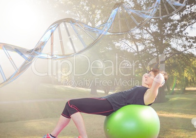 woman doing exercise with the baal in the park. DNA chain over her