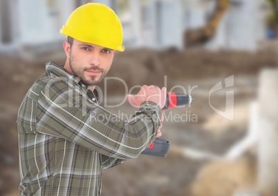 Carpenter with drill on building site