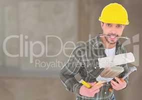 Construction Worker with tools in front of construction site