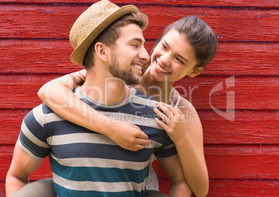 young couple looking each other with red wood background