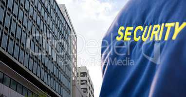 Security person with blue jacket  in front of a big building