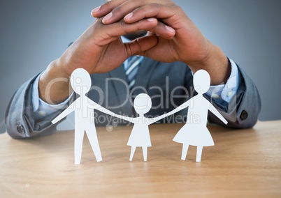 Cut out family under protective hands