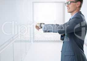 Businessman holding smart watch in bright corridor