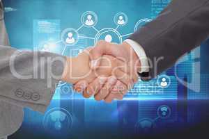 Businessman shaking their hands with a blue digital background