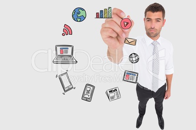 Business man drawing colored icons on the screen against white background