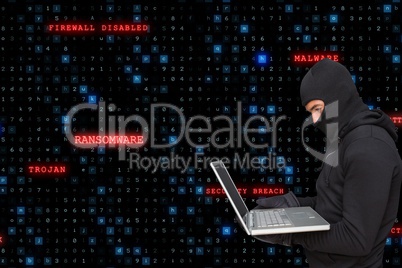 Sied view of cyber criminal wearing an hood is hacking from a laptop against matrix code rain backgr