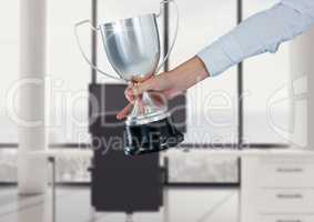 business hand with trophy in the office