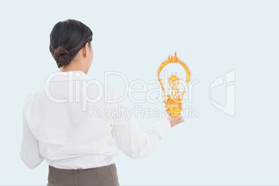 Businesswoman holding a digital light bulb with white background Businesswoman holding a digital light bulb with white background