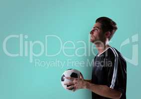 soccer player looking up with ball on hands. blue background