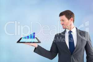 Businessman holding a tablet with graphics