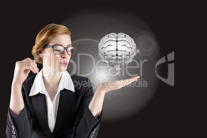 Businesswoman holding a digital brain with black background