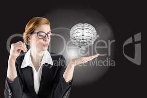 Businesswoman holding a digital brain with black background