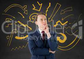 Business man thinking against grey wall with yellow arrow graphics