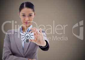Business woman holding out card showing lightbulb graphic against brown background