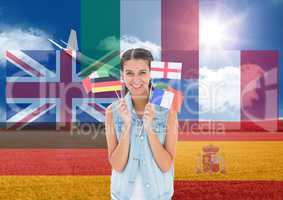 main language flags around young woman with flags with plane behind in field