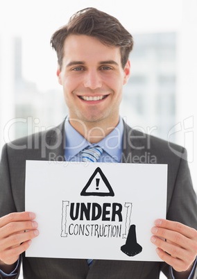 grey construction doodle on card held by business man smiling