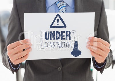 Navy construction doodle on card held by business man mid section