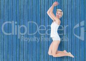 fitness woman jumping with blue wood background