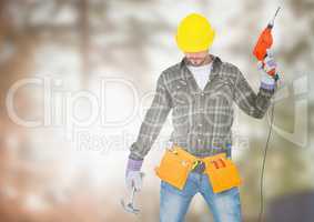 Carpenter  with drill posing on building site